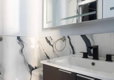 a white bathroom with a sink and a toilet at Midtown West 2 Bedroom Furnished Apartment Rental in New York