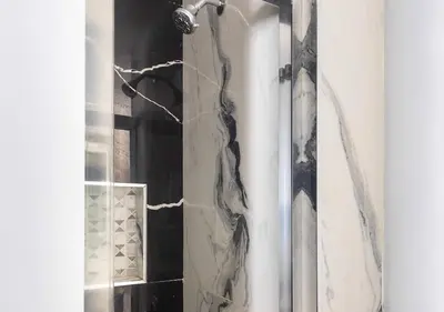 a shower with a shower curtain in a bathroom at Midtown West 2 Bedroom Furnished Apartment Rental in New York