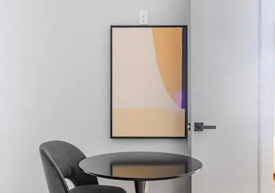 a table and chairs next to a wall with a picture at Midtown West 2 Bedroom Furnished Apartment Rental in New York