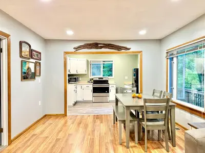 a kitchen and dining room with a table and chairs at Cayuga lake cottage with private lake access in Washingtonville