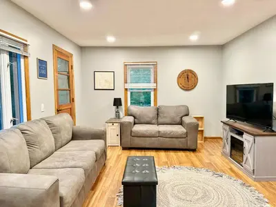 a living room with a couch and a television at Cayuga lake cottage with private lake access in Washingtonville