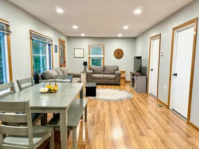 a living room with a table and a couch at Cayuga lake cottage with private lake access in Washingtonville