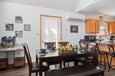 a kitchen and dining room with a table and chairs at Hot Tub Fire-place Game Room Arrowhead Lake in Thornhurst