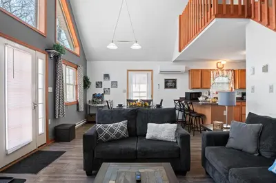 a living room with two couches and a kitchen at Hot Tub Fire-place Game Room Arrowhead Lake in Thornhurst