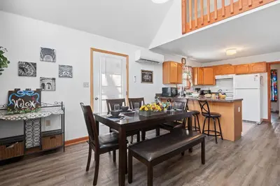 a kitchen and dining room with a table and chairs at Hot Tub Fire-place Game Room Arrowhead Lake in Thornhurst