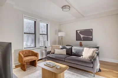 a living room with a couch and a chair at UWS 2br w wd doorman gym nr Central Park NYC-1082 in New York
