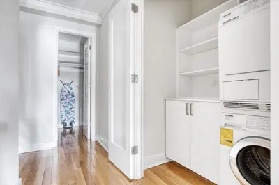 a laundry room with white cabinets and a washer and dryer at UWS 2br w wd doorman gym nr Central Park NYC-1082 in New York