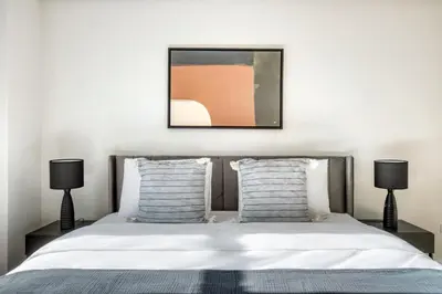 a bedroom with a bed with two lamps at UWS 2br w wd doorman gym nr Central Park NYC-1082 in New York