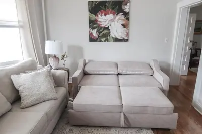 a living room with a couch and a table at Cozy 2BR 5min to NYC Train and 10min to Seton Hall in West Orange