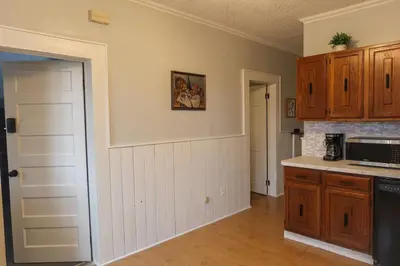 a kitchen with wooden cabinets and a counter top at Cozy 2BR 5min to NYC Train and 10min to Seton Hall in West Orange