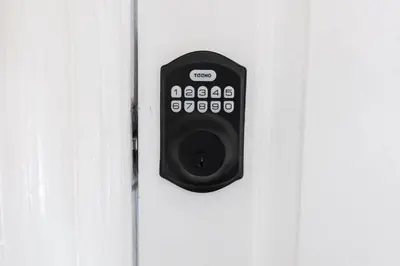 a door with a remote control attached to it at Cozy Attic Studio for 2 5min to NYC Train Station in West Orange