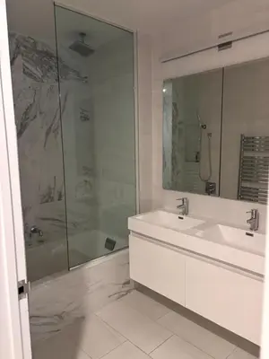 a white bathroom with a sink and a shower at Best Location in Greenwich Village in New York