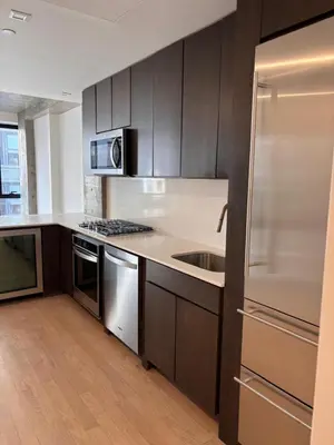 a kitchen with a stainless steel refrigerator and a sink at Best Location in Greenwich Village in New York