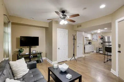 a living room with a couch and a ceiling fan at 1 Mi to Dtwn Wilmington Convenient and Cozy Home! in Wilmington
