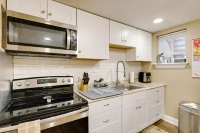 a kitchen with a stove and a microwave at 1 Mi to Dtwn Wilmington Convenient and Cozy Home! in Wilmington
