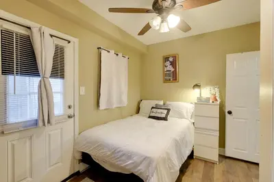 a bedroom with a bed and a ceiling fan at 1 Mi to Dtwn Wilmington Convenient and Cozy Home! in Wilmington