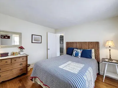 a bedroom with a bed and a dresser at The White House by Leavetown Vacations in Wrightsville