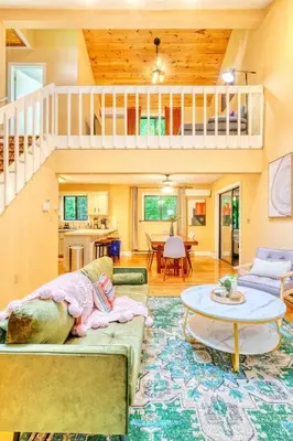 a living room with a couch and a table at Grand Woodland Retreat - Hot Tub - Game Room in Gouldsboro