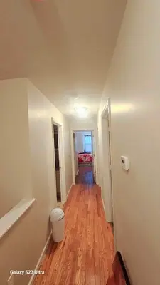 a hallway of a house with a hard wood floor at Divine Villa and Resort - 32 Evergreen in Newark