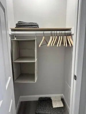 a walk in closet with white walls and wooden utensils at Philly Getaway - Chic Stay Near Center City in Philadelphia