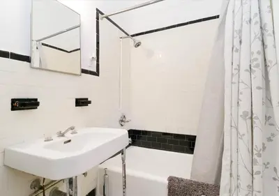 a white bathroom with a sink and a bath tub at Outdoor Space Washer Dryer Dishwasher 3Beds Apt, June to Aug 90 days stay required in New York