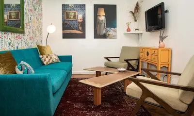 a living room with a blue couch and two chairs at 3BR Loft! Mins to Time Square!, June to Aug 90 days stay required in New York