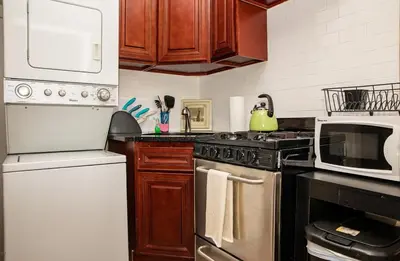 a kitchen with a stove and a microwave at 3BR Loft! Mins to Time Square!, June to Aug 90 days stay required in New York