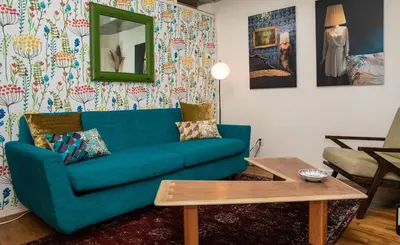 a living room with a blue couch and a table at 3BR Loft! Mins to Time Square!, June to Aug 90 days stay required in New York