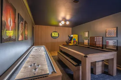 a room with a ping pong table and a pool table at Scandinavian Retreat Hot Tub, Pool, Game Rm in Gouldsboro