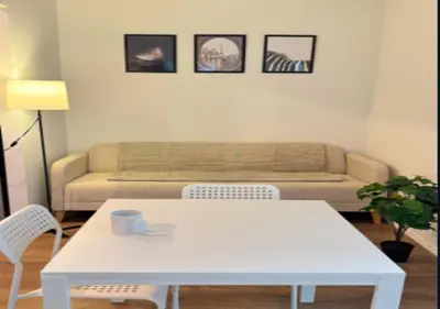 a living room with a white table and a couch at Newly Reno 1BR! Murray Hill! in New York