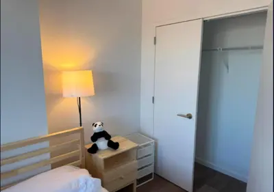 a bedroom with a panda bear sitting on a night stand at Newly Reno 1BR! Murray Hill! in New York