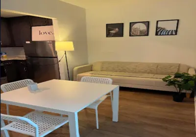 a living room with a table and a couch at Newly Reno 1BR! Murray Hill! in New York