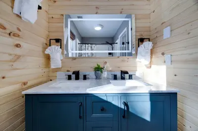 a bathroom with a sink and a mirror at Poconos Chalet Hot Tub, Game Room, Sleeps 10 in Albrightsville