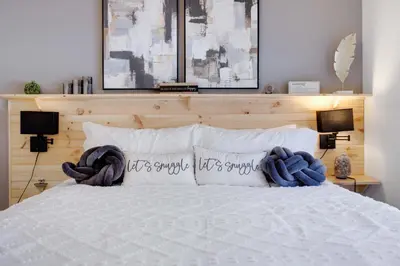 a bedroom with a white bed with two pillows at Poconos Chalet Hot Tub, Game Room, Sleeps 10 in Albrightsville
