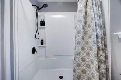 a bathroom with a shower with a shower curtain at Poconos Chalet Hot Tub, Game Room, Sleeps 10 in Albrightsville