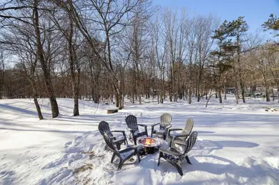 four chairs around a table in the snow at Poconos Chalet Hot Tub, Game Room, Sleeps 10 in Albrightsville