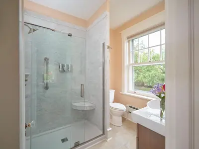 a bathroom with a shower and a toilet and a sink at Mooreland Garden Inn in Carlisle