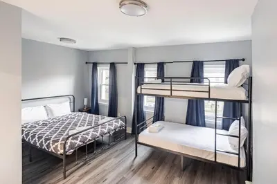 a bedroom with two bunk beds and a window at Prime Location Explore NYC in West New York