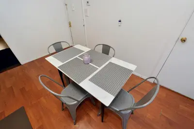 a table with chairs and a purple mug on it at Cozy 2BR Apartment in the Heart of Chelsea in New York