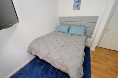 a bed in a corner of a room at Cozy 2BR Apartment in the Heart of Chelsea in New York