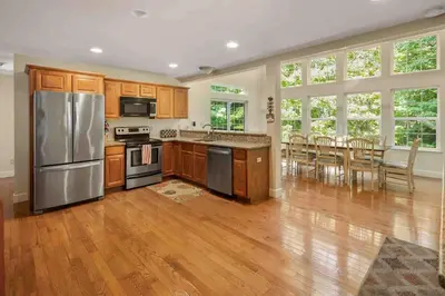 a kitchen with wooden cabinets and stainless steel appliances at Huge Masthope retreat king sz bed , hot tub , game room in Lackawaxen