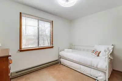a living room with a white couch and a window at 3 Mi to Tobyhanna State Park Home with Serene Deck! in Tobyhanna