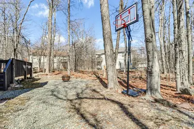 a basketball hoop in the middle of a forest at 3 Mi to Tobyhanna State Park Home with Serene Deck! in Tobyhanna