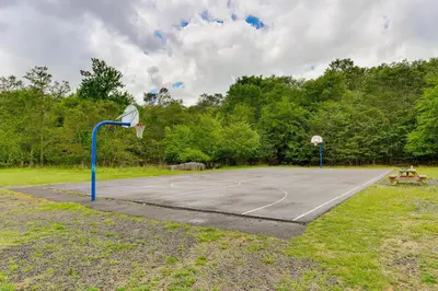 a basketball court with a hoop in a park at 3 Mi to Tobyhanna State Park Home with Serene Deck! in Tobyhanna