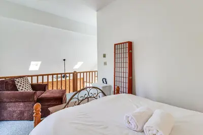 a bedroom with a bed and a couch at 3 Mi to Tobyhanna State Park Home with Serene Deck! in Tobyhanna