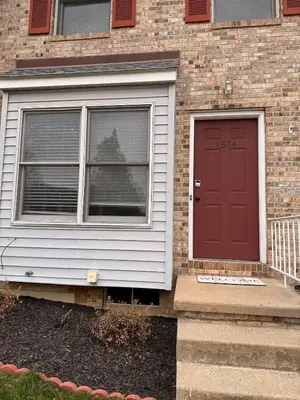 a house with a red door and a window at Town House near Geisinger Medical Center in Danville
