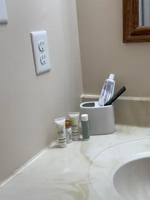 a bathroom sink with a toothbrush and other items on the counter at Town House near Geisinger Medical Center in Danville