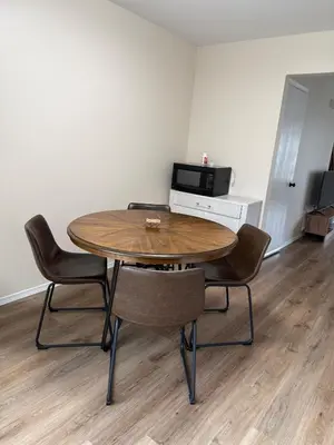 a table and chairs in a room with a microwave at Town House near Geisinger Medical Center in Danville