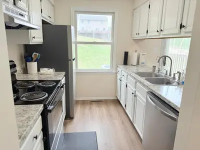 a kitchen with a sink and a stove top oven at Town House near Geisinger Medical Center in Danville