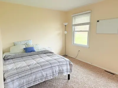 a bedroom with a large bed with a window at Town House near Geisinger Medical Center in Danville